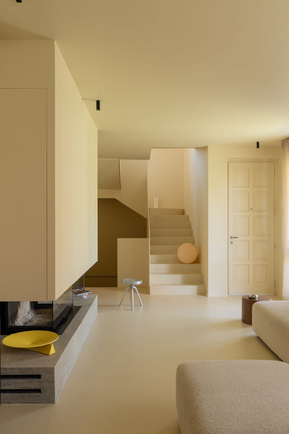 salotto con camino e scala sui toni del giallo