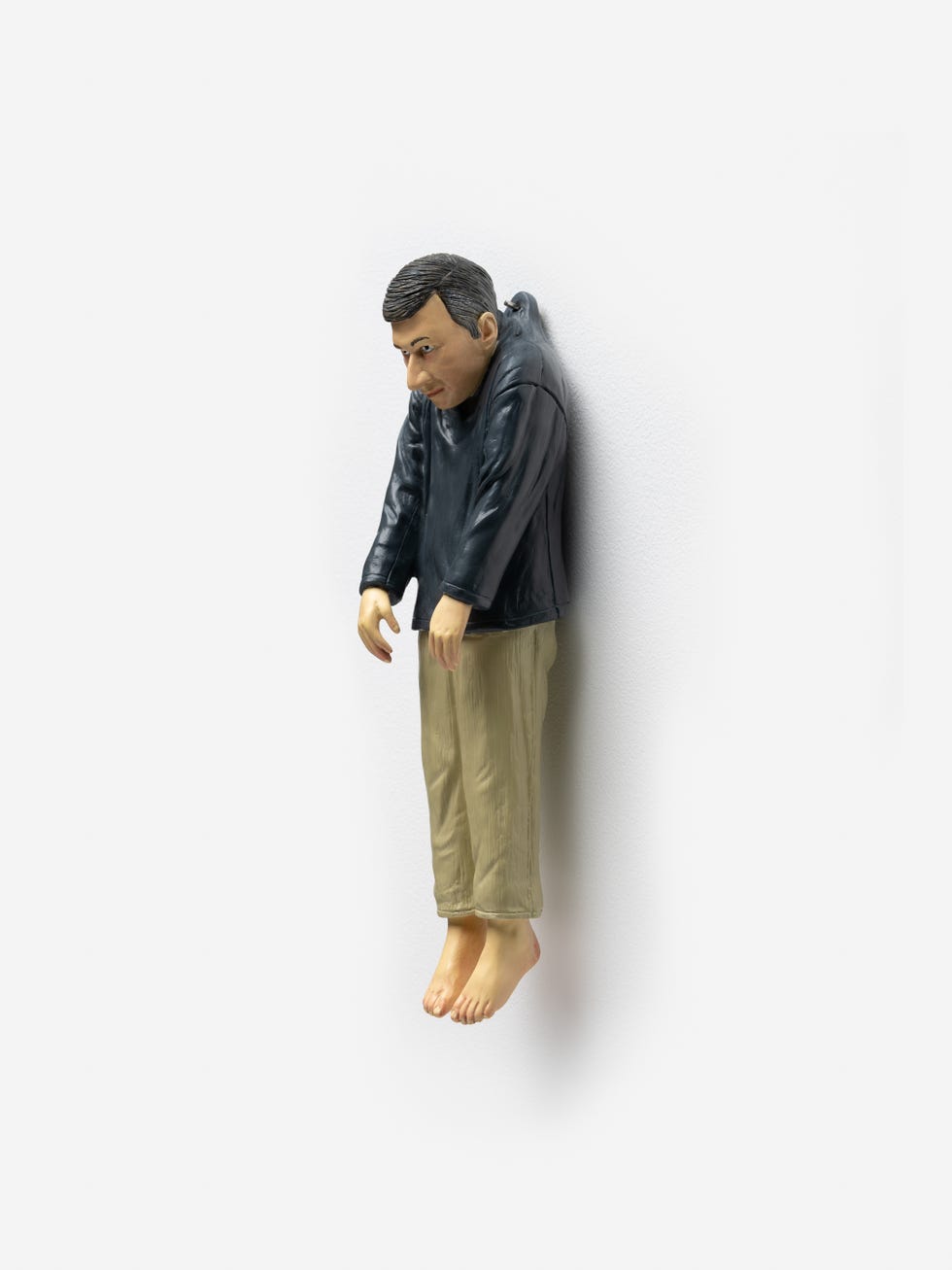 a figurine of a person with arms hanging down