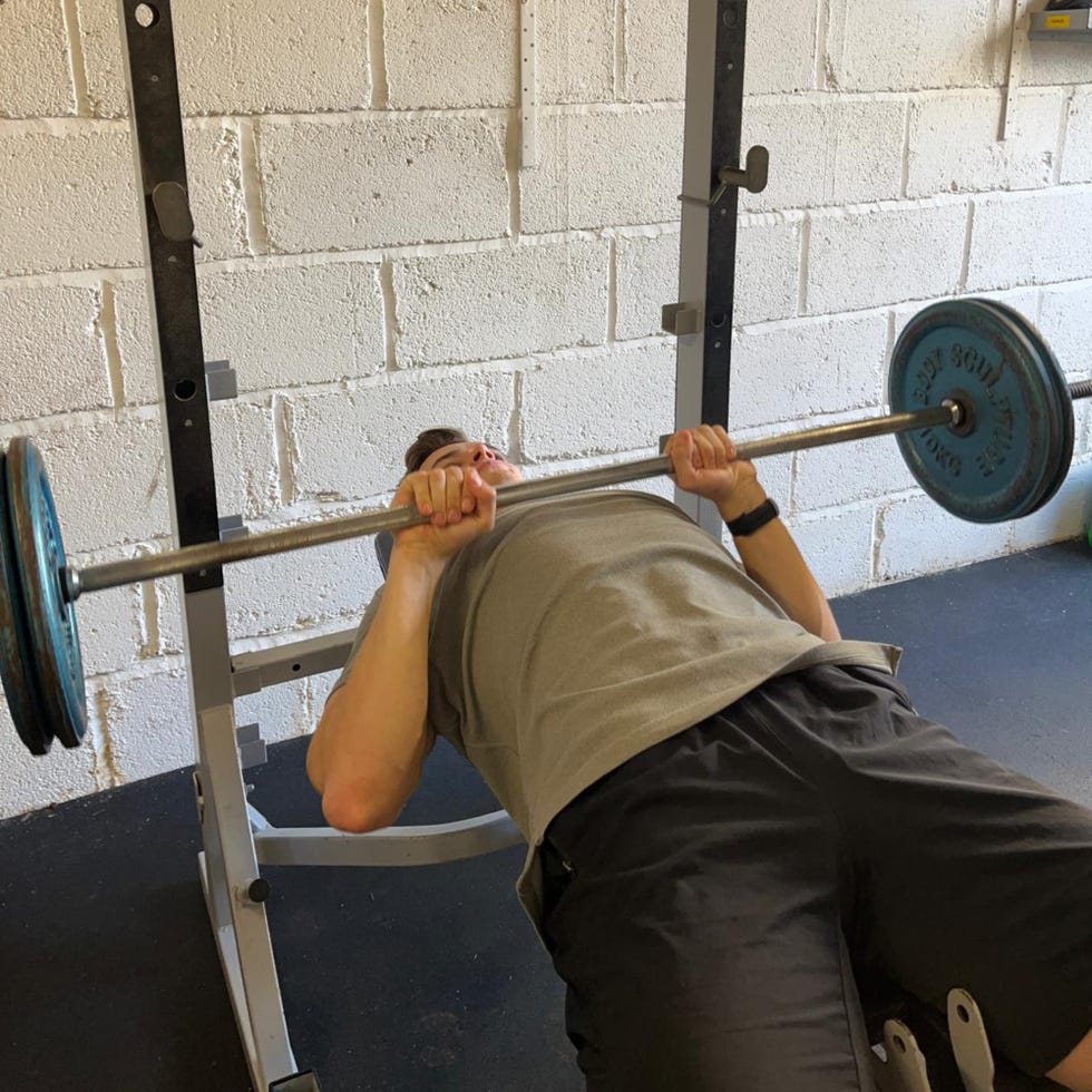 individual performing a bench press exercise