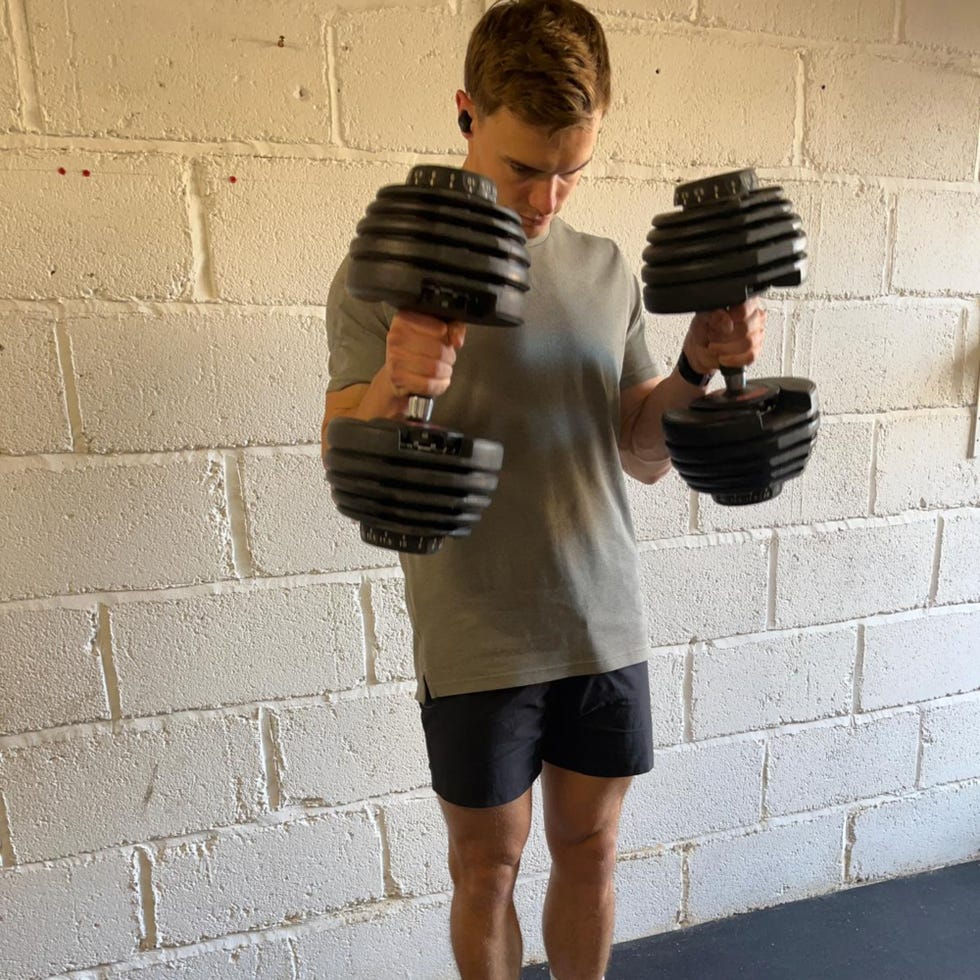 individual performing a strength training exercise with dumbbells