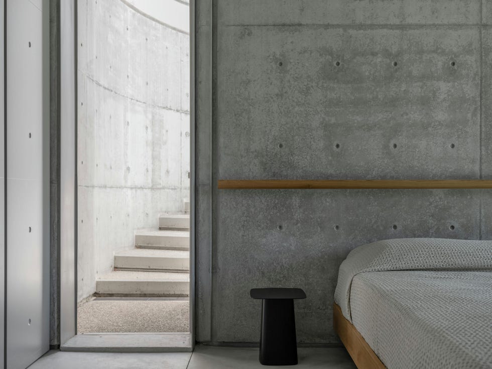 interior view of a minimalist bedroom with a connection to a stairway