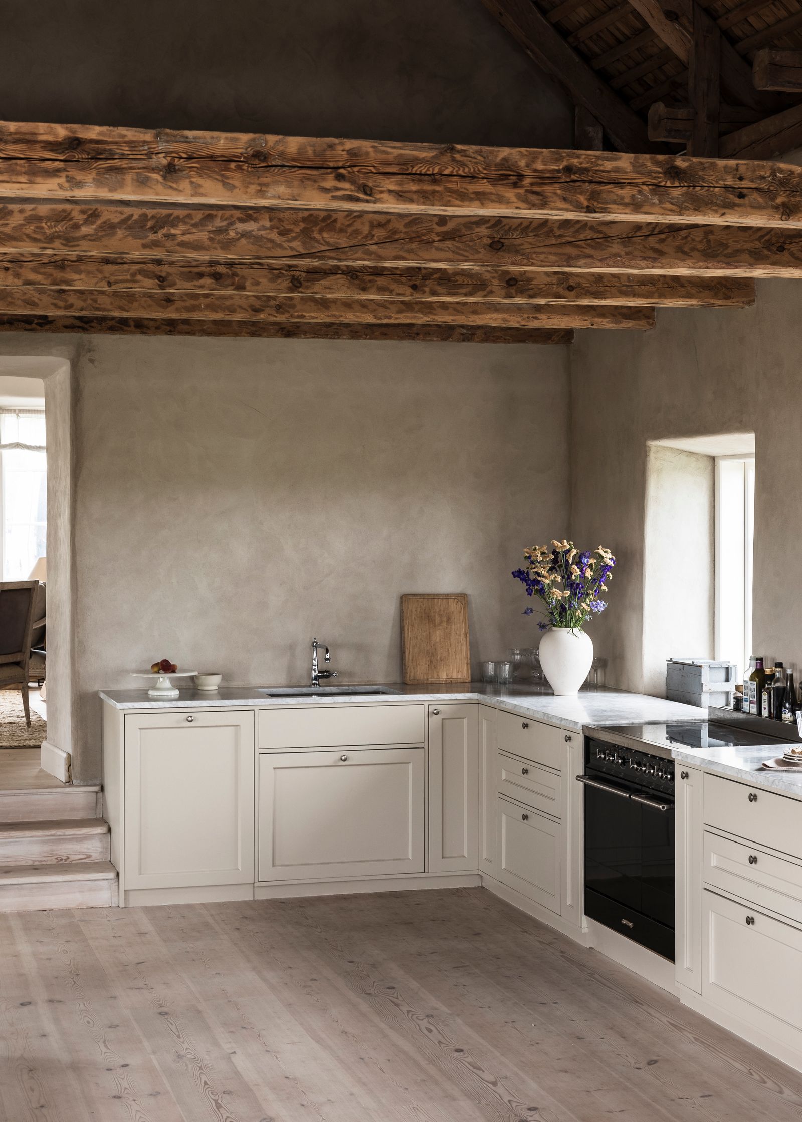 La cucina su misura è dipinta con una tinta chiara che si armonizza con il resto della casa e presenta raffinate...