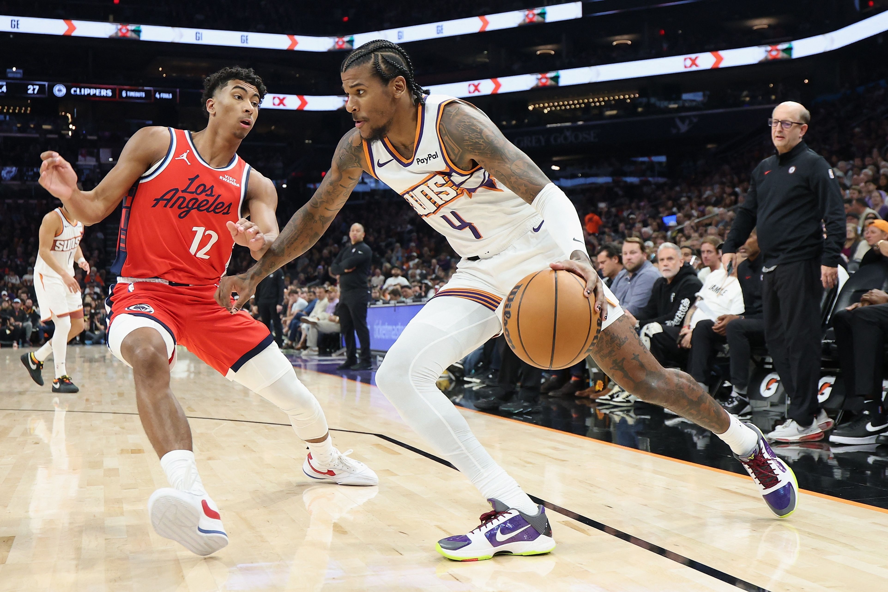 PHOENIX, ARIZONA - NOVEMBER 06: Jalen Green #4 of the Phoenix Suns drives the ball against Cam Christie #12 of the LA Clippers during the first half of the NBA game at Mortgage Matchup Center on November 06, 2025 in Phoenix, Arizona. NOTE TO USER: User expressly acknowledges and agrees that, by downloading and or using this photograph, user is consenting to the terms and conditions of the Getty Images License Agreement. Christian Petersen/Getty Images/AFP (Photo by Christian Petersen / GETTY IMAGES NORTH AMERICA / Getty Images via AFP)