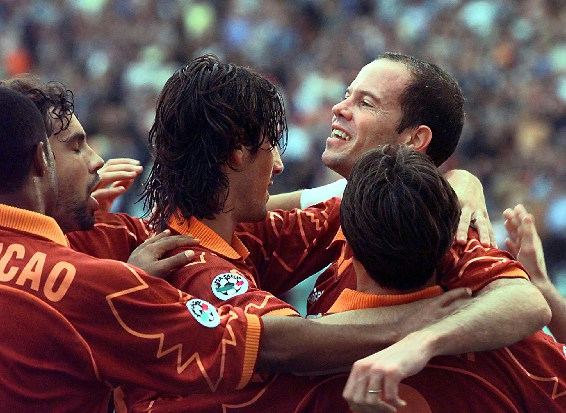 Roma's Brazilian ace Antonio Carlos Zago, right, is celebrated by teammates   as he reacts after scoring to Cagliari during their Italian League soccer match at Rome's Olympic stadium, Sunday, October 31, 1999.  The match ended 2-2. (AP Photo/Plinio Lepri)