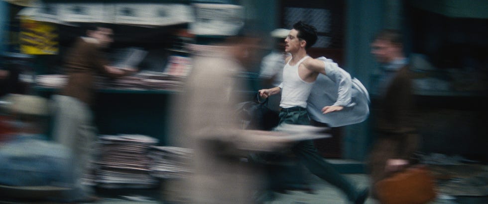 a person running through a bustling street scene