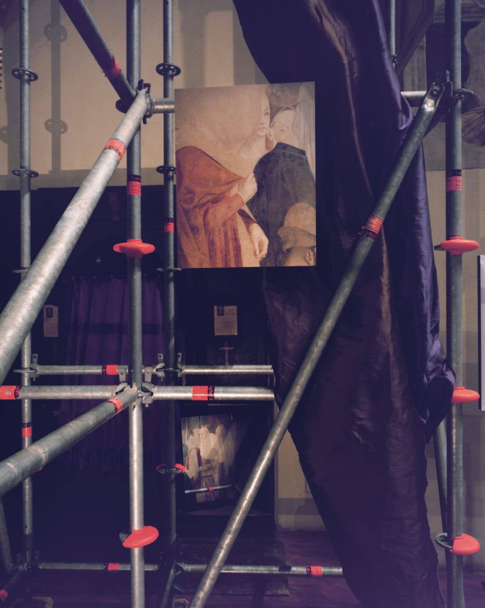 scaffolding in a gallery with partially obscured artworks