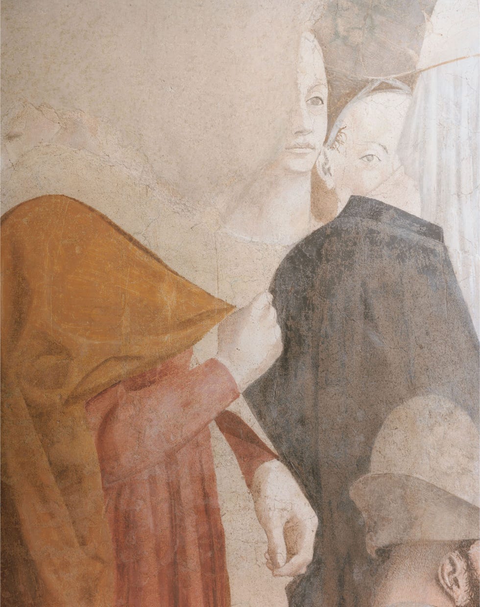 two figures interacting one wearing a red cloak