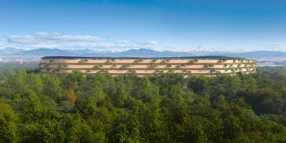 ospedale-malpensa-zaha-hadid modern building surrounded by trees and mountains in the background
