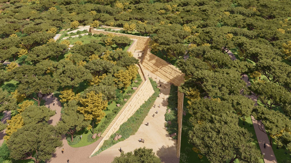 aerial view of a landscaped area featuring walking paths and a large structured frame