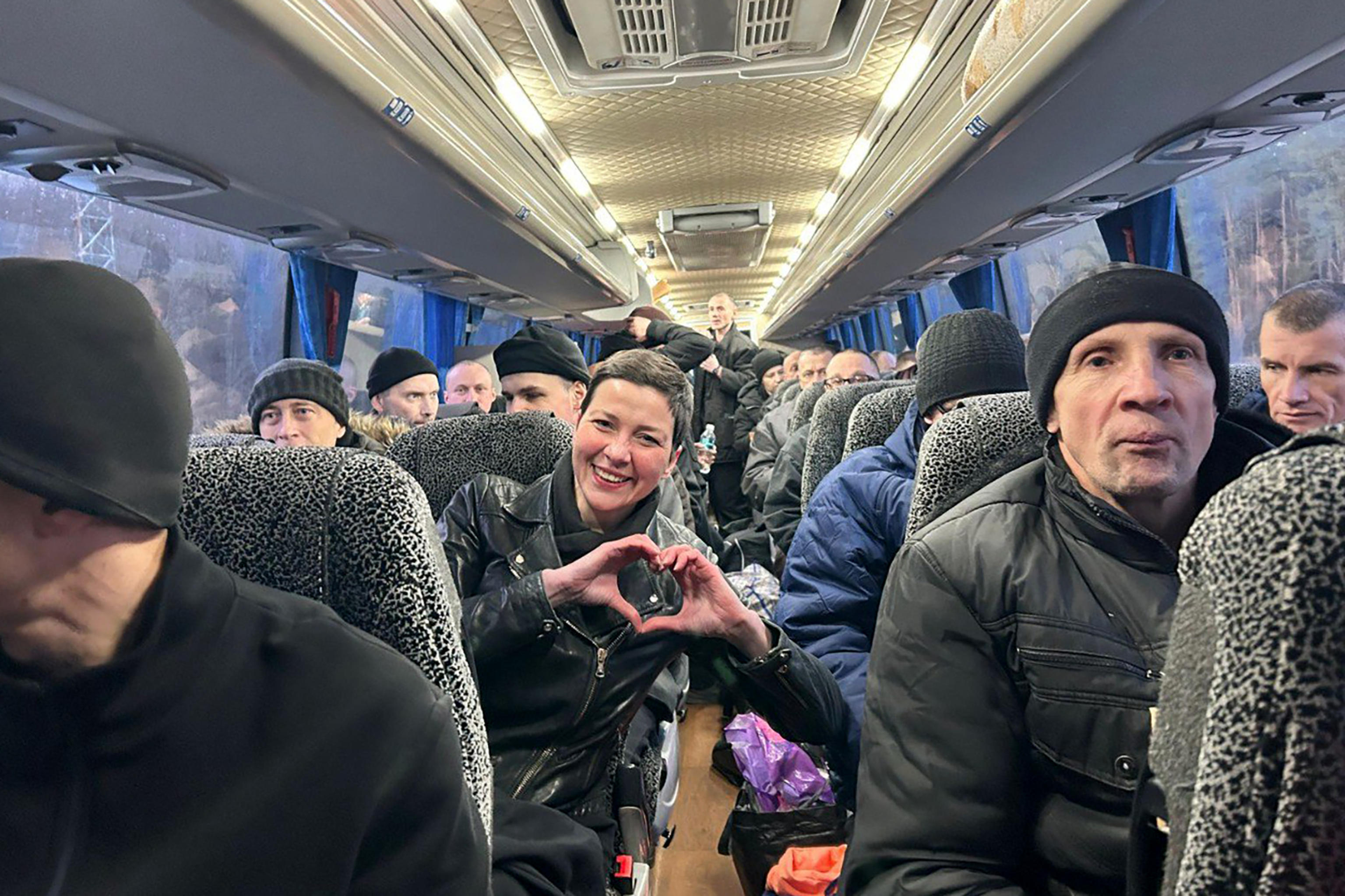 This handout photograph taken and released by the Coordination Headquarters for the Treatment of Prisoners of War on December 13, 2025, shows Maria Kalesnikava (C), a coordinator of Viktar Babaryka's campaign headquarters, making a heart sign with...