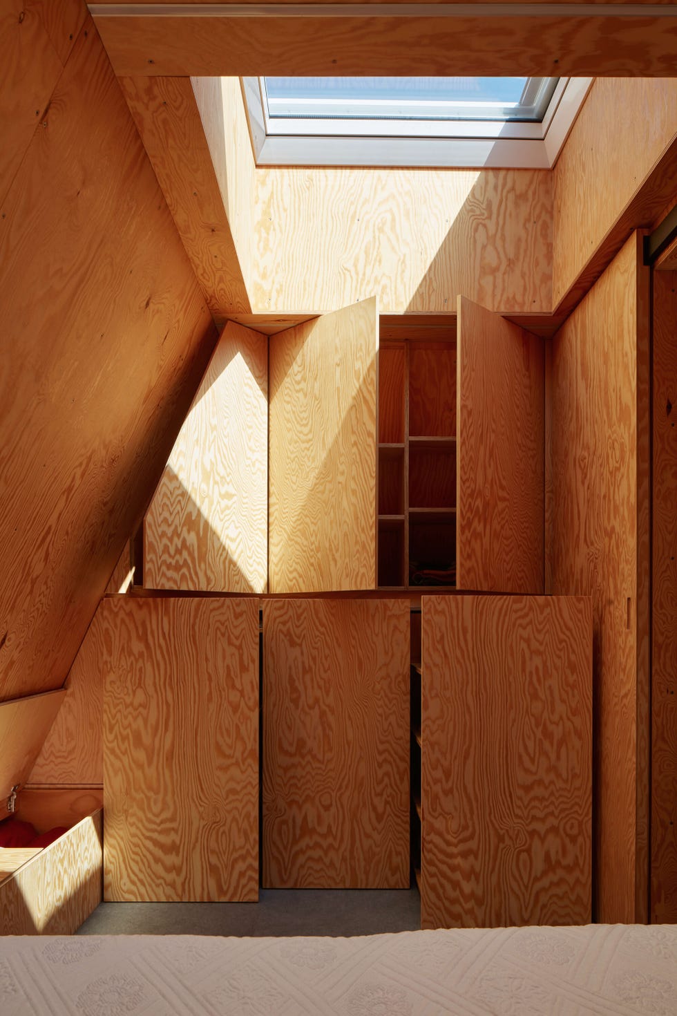 interior space featuring wood cabinetry and a skylight