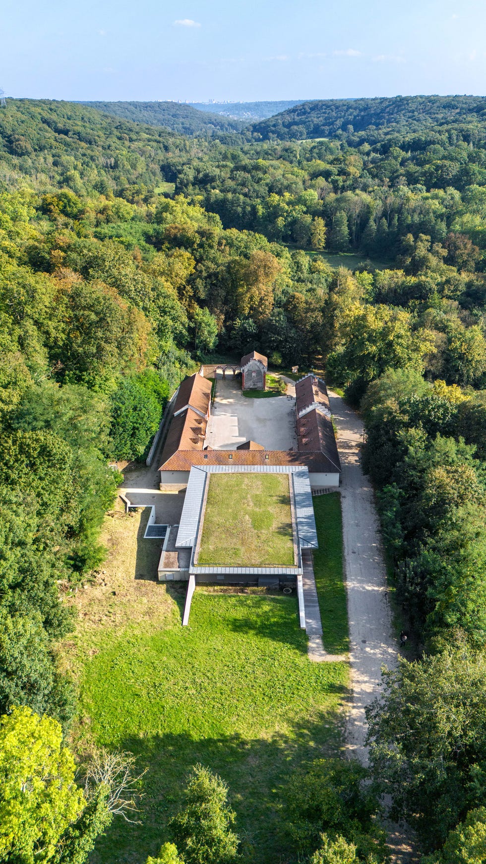 aerial view of a structured complex surrounded by greenery