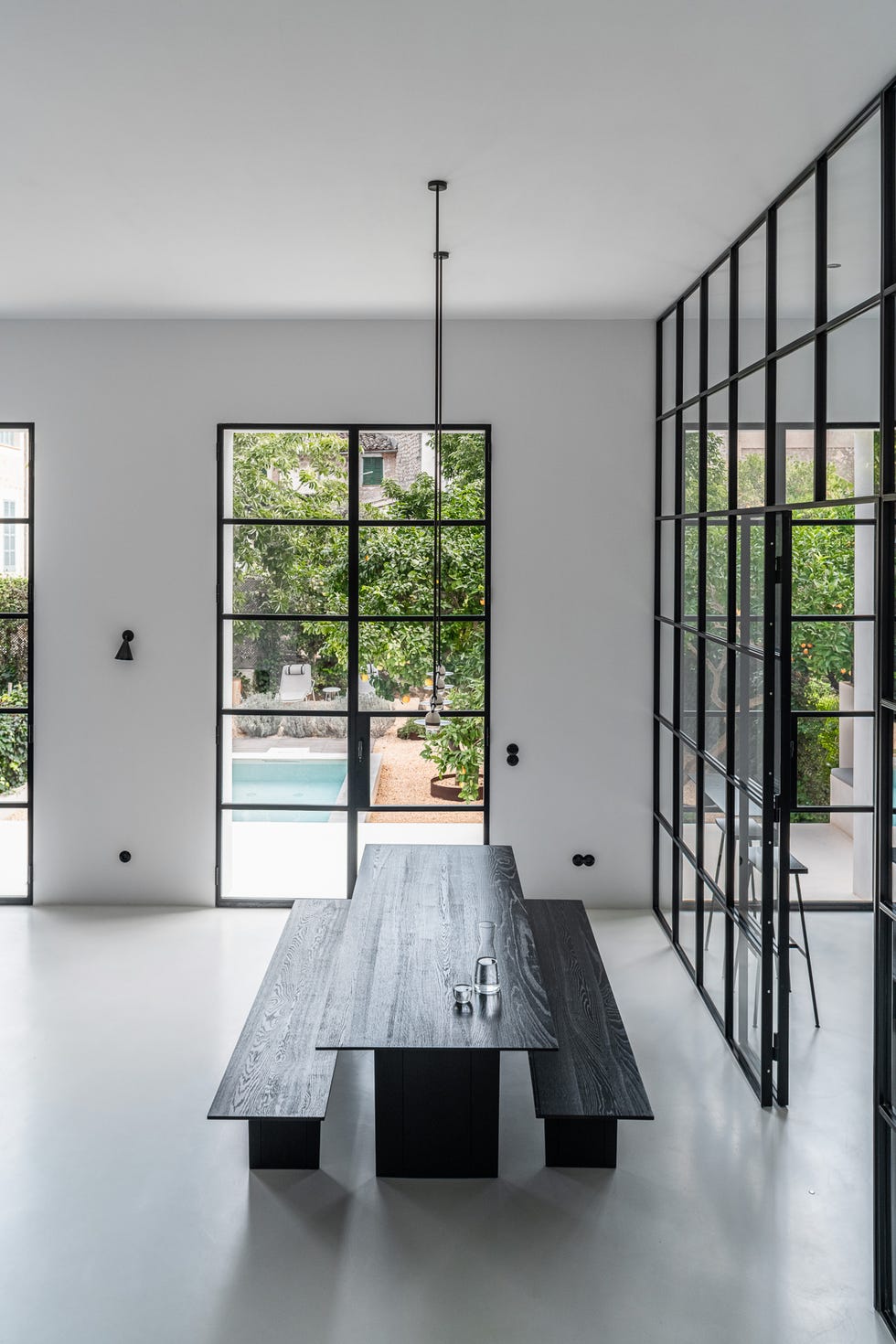 modern dining area with a view of a garden and pool