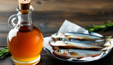 Bottiglia di colatura di alici accanto a piattino con alici