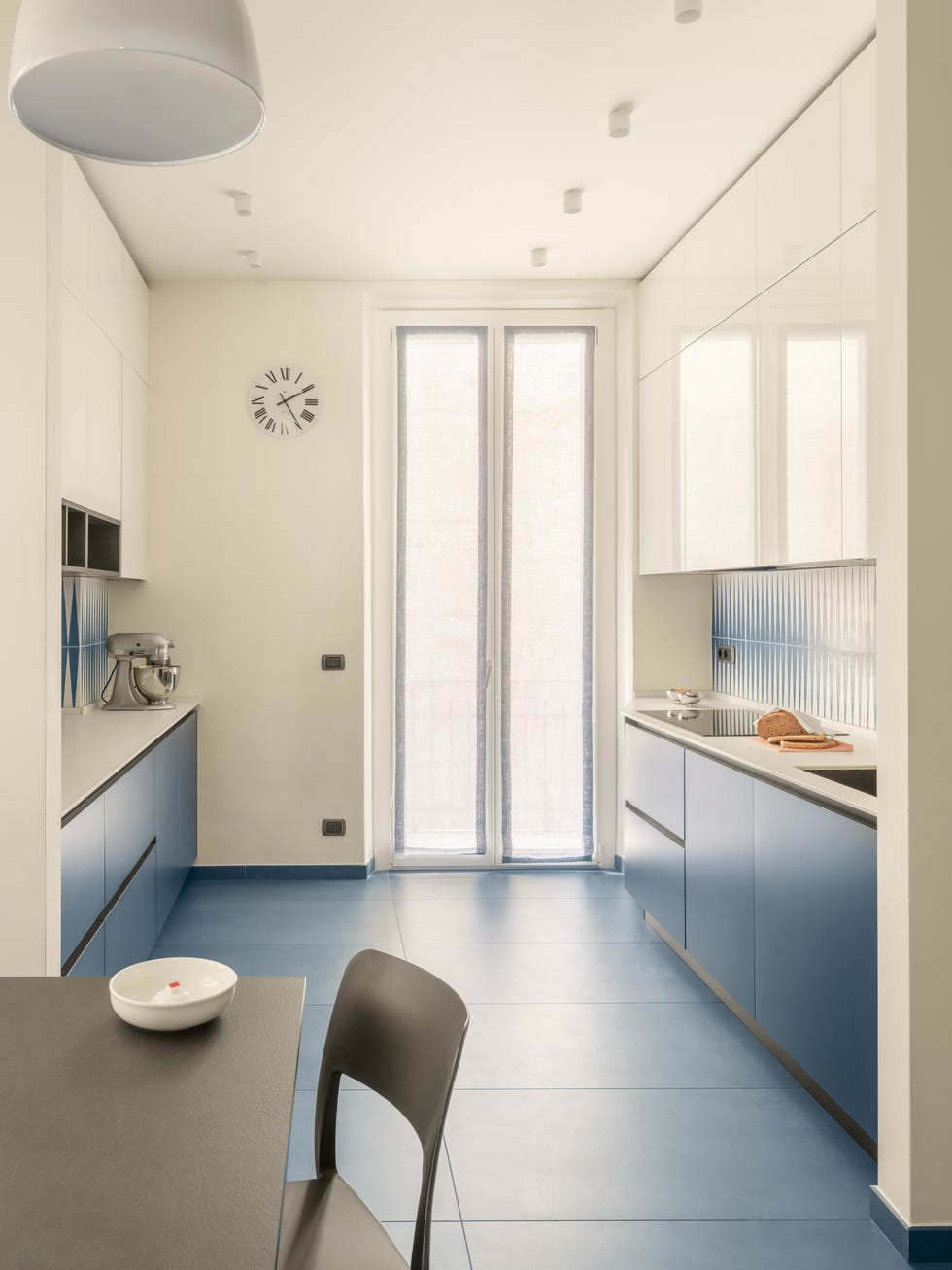 modern kitchen with blue cabinetry and minimalist design