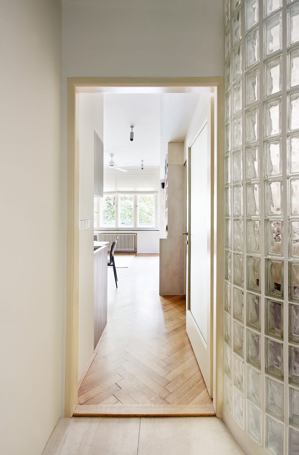 view through a doorway into a modern kitchen space