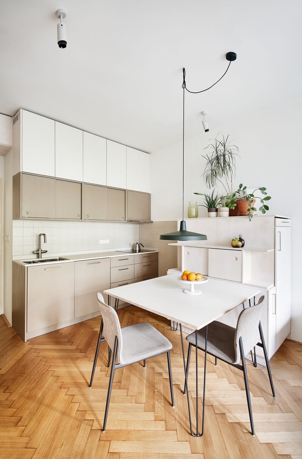 modern kitchen and dining area with a table and chairs
