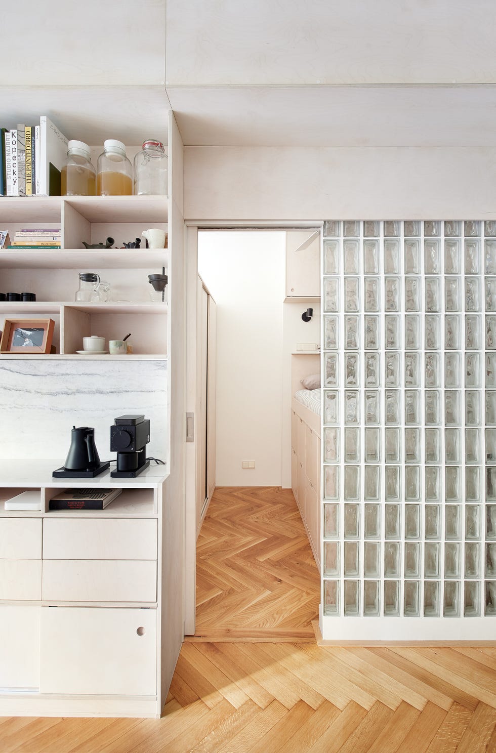minimalist interior view featuring a kitchen area and a hallway