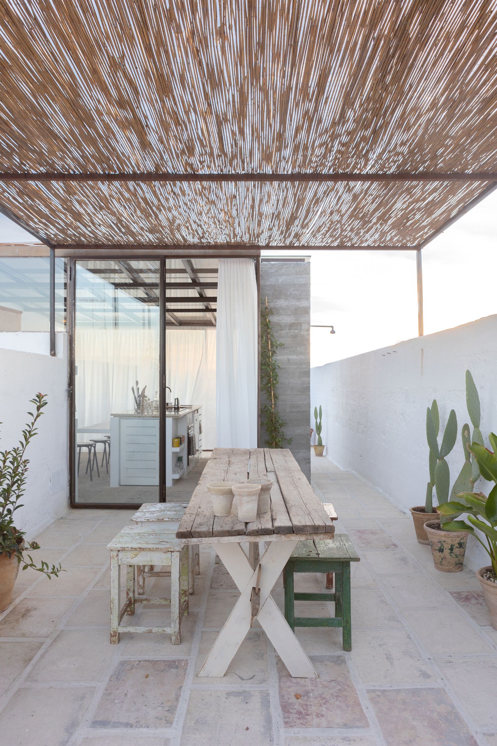 Larea dining e il lungo tavolo con assi di legno naturale nellarea più riparata del rooftop. Il tavolo e le sedienbsp...