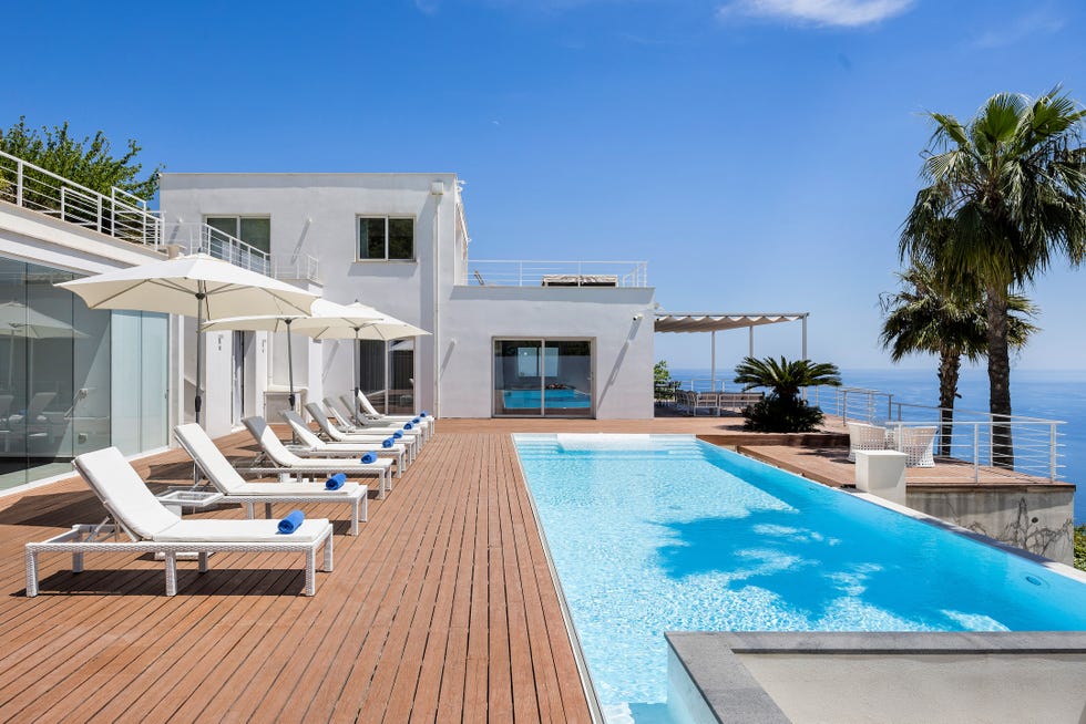 modern villa with pool and sun loungers