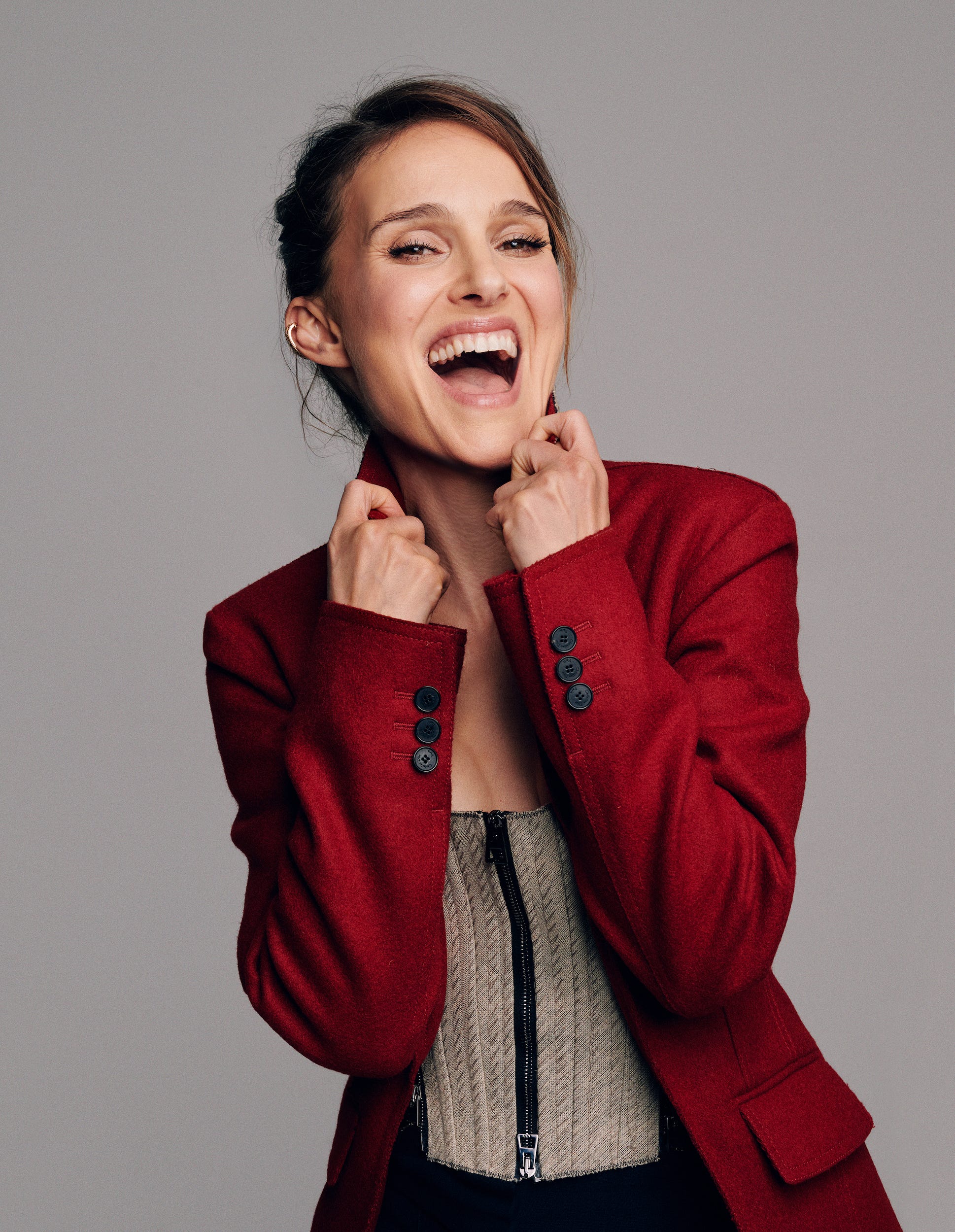 woman in a red blazer and beige textured top