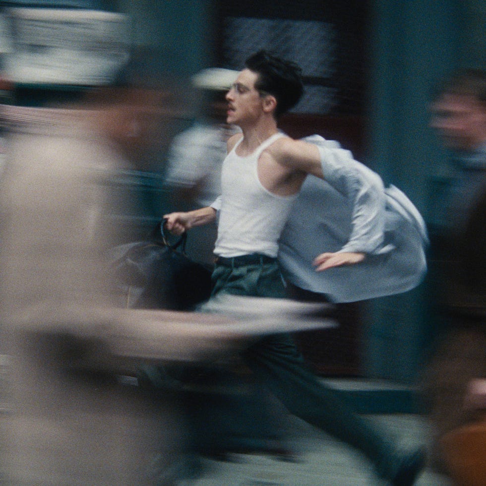 A person running dynamically through a bustling street scene.