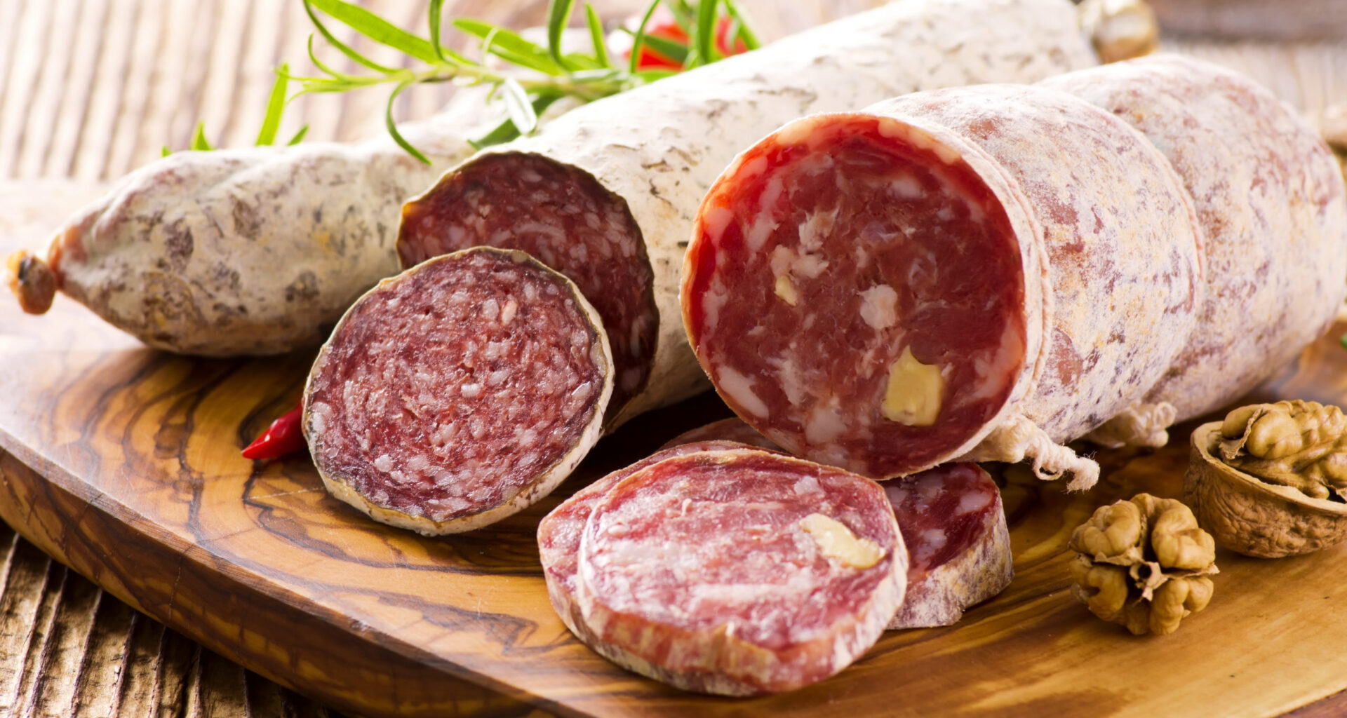 Salami tagliati su un tagliere; concept: salumi, salame, muffa, insaccati