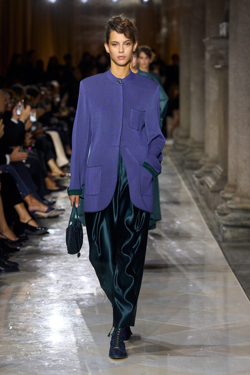 model walking down a fashion runway wearing a stylish outfit