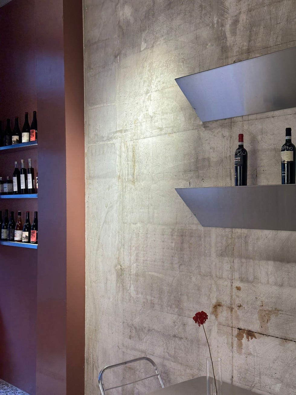 interior of a minimalist wine bar with shelves holding wine bottles