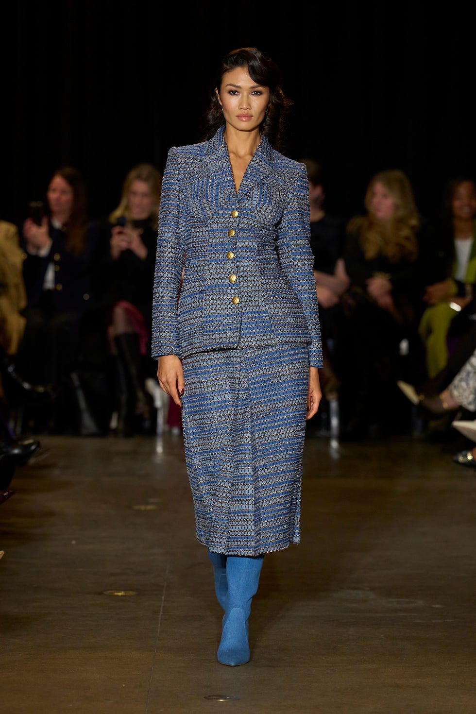 fashion model on a runway wearing a blue twopiece outfit