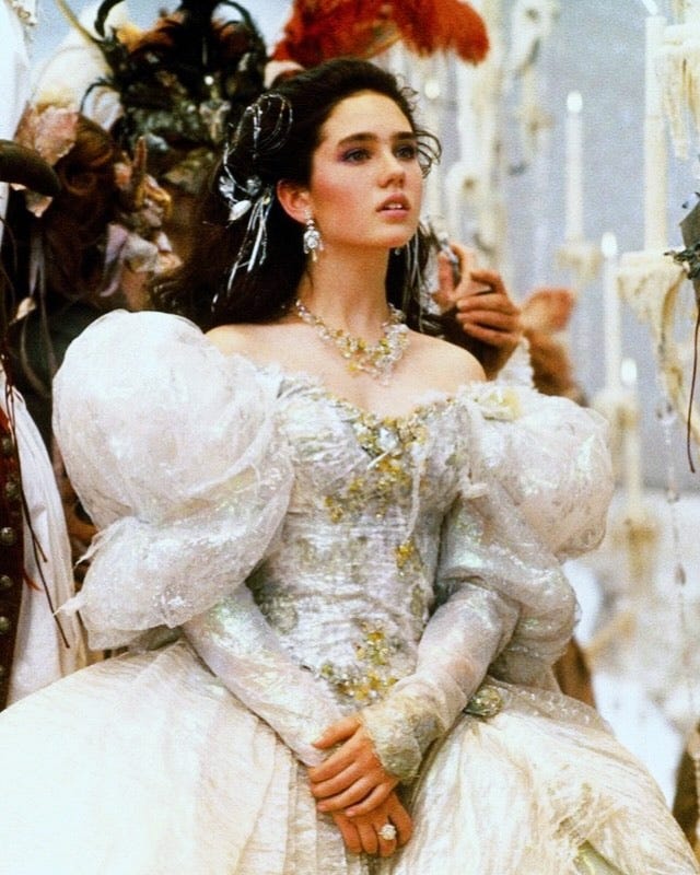 woman in an opulent gown at a masquerade event