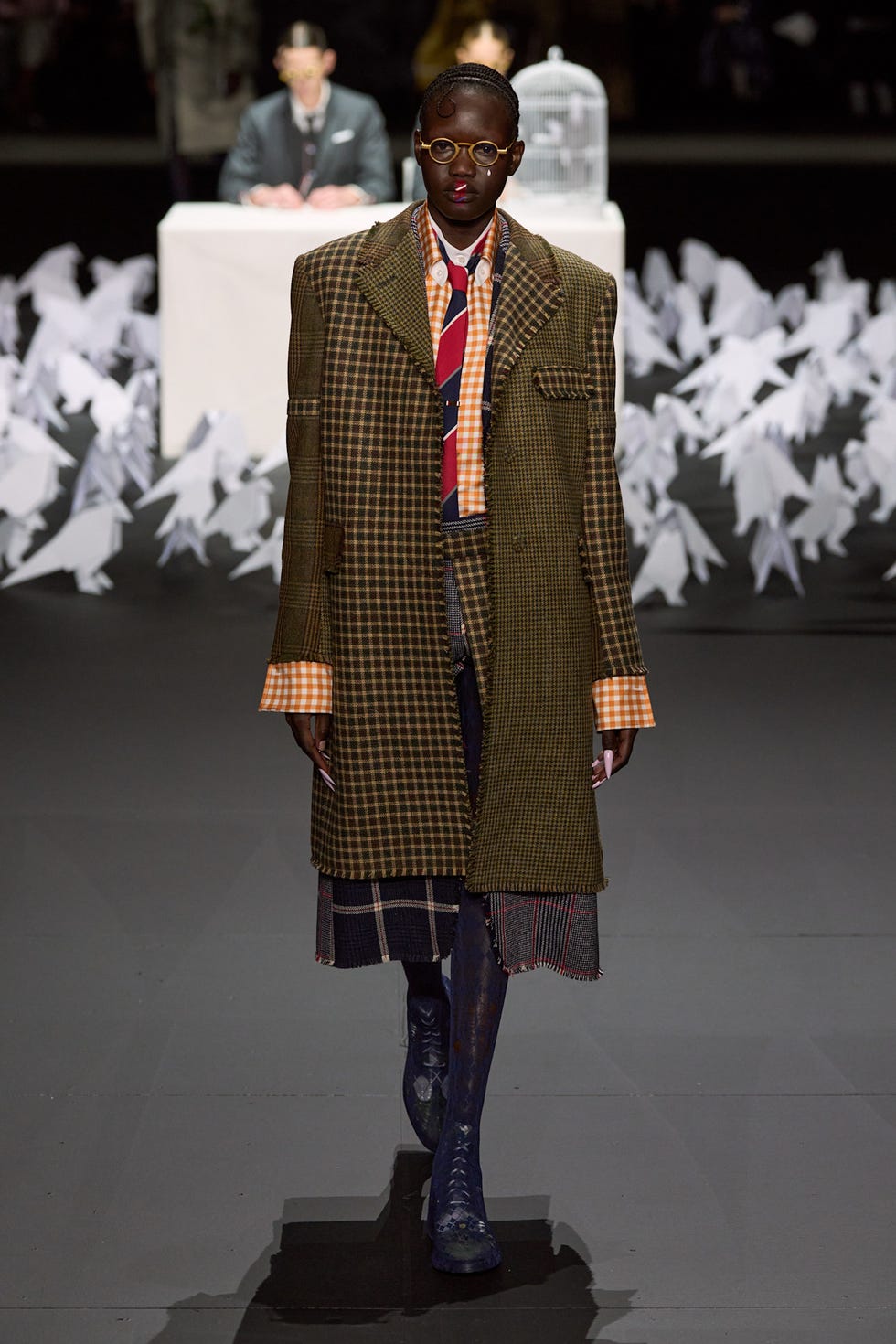 fashion model walking on a runway with a unique outfit