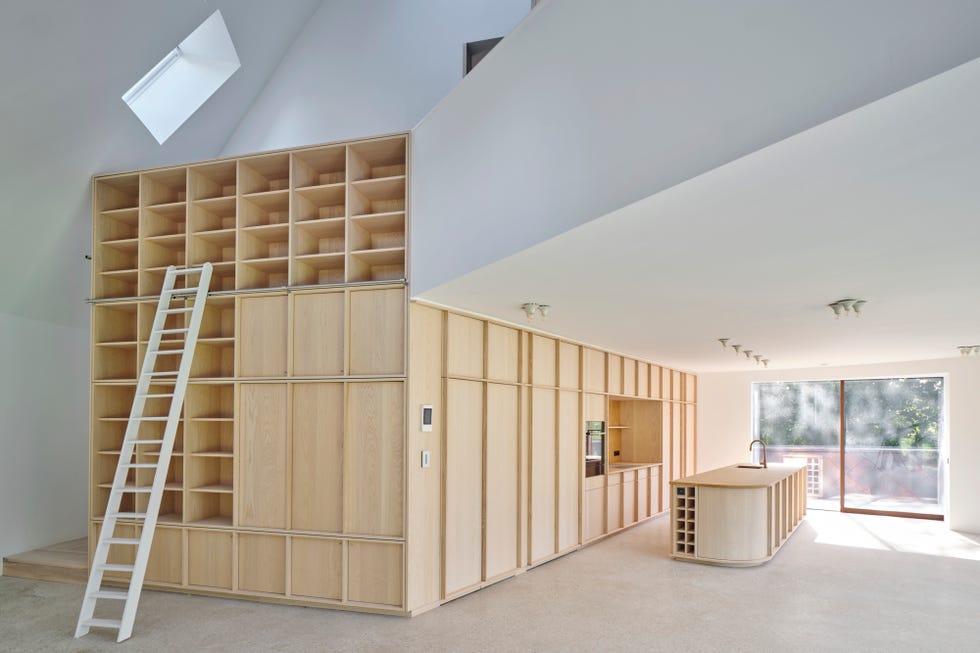 modern interior of a lightfilled living space with wooden shelving and ladder