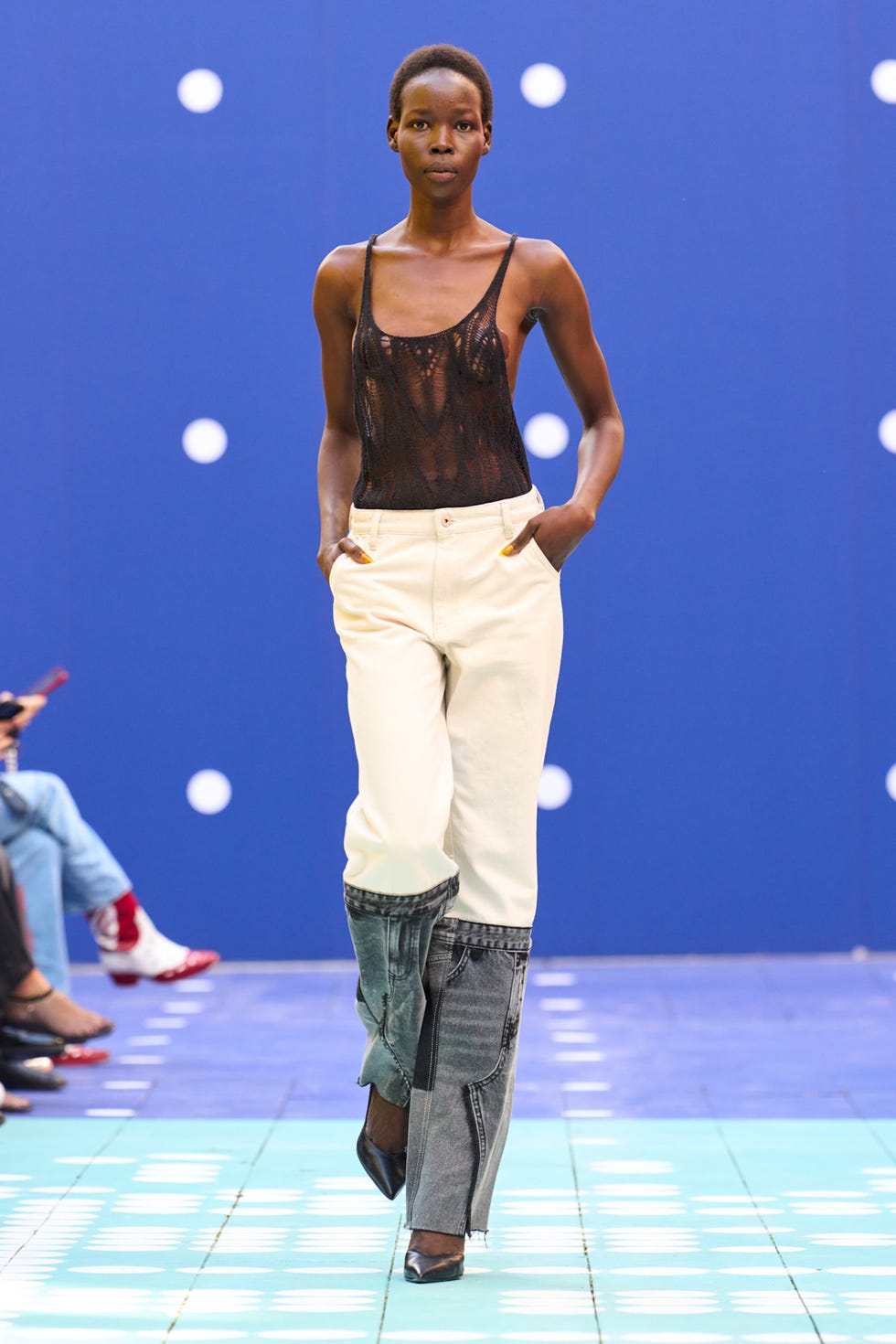 model showcasing fashion on a runway with a blue background