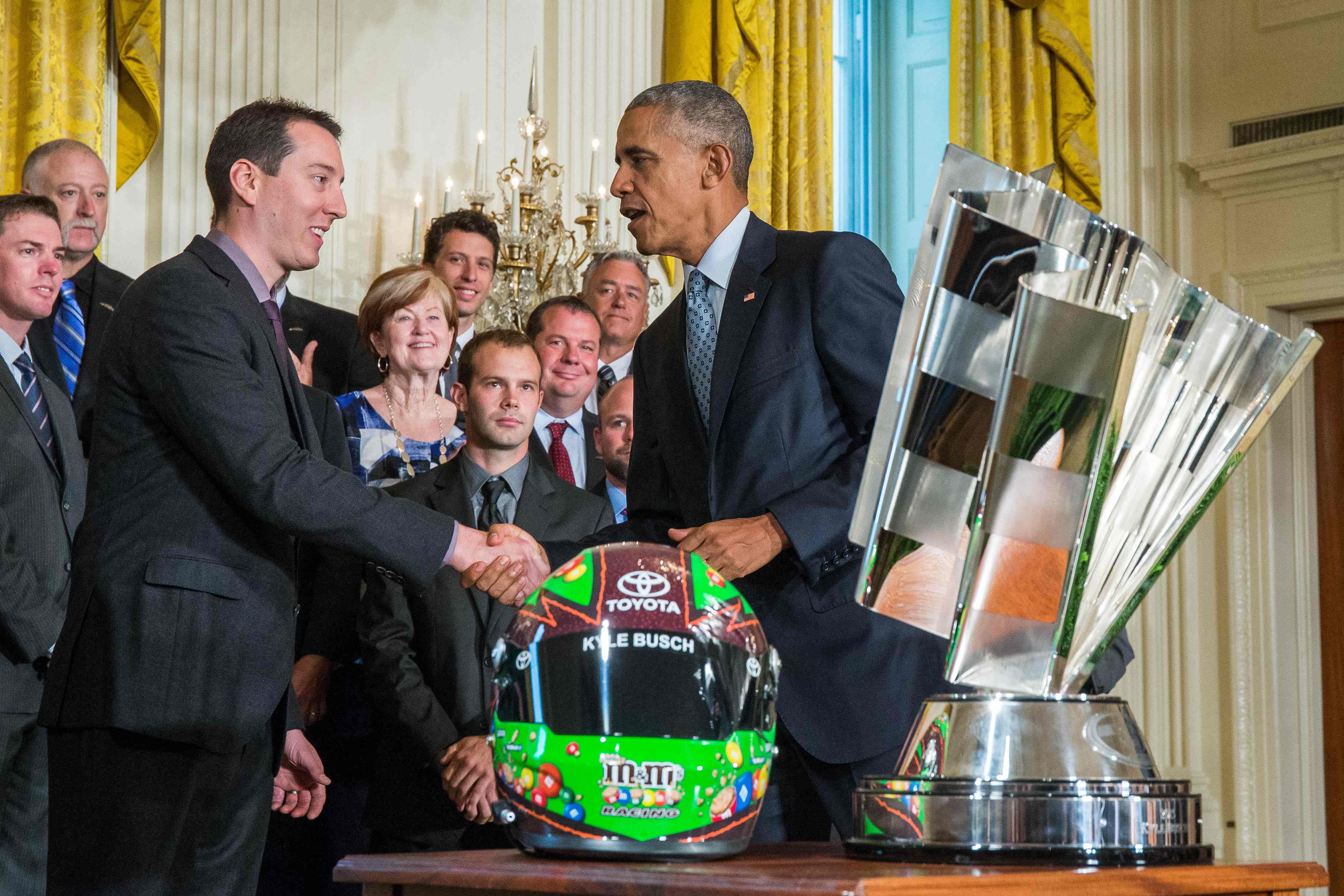 (FILES) NASCAR driver Kyle Busch gives US President Barack Obama a helmet during a reception for Busch and his team members celebrating his win in the NASCAR Spring Cup Series Championship in the East Room at the White House on September 28, 2016 ...