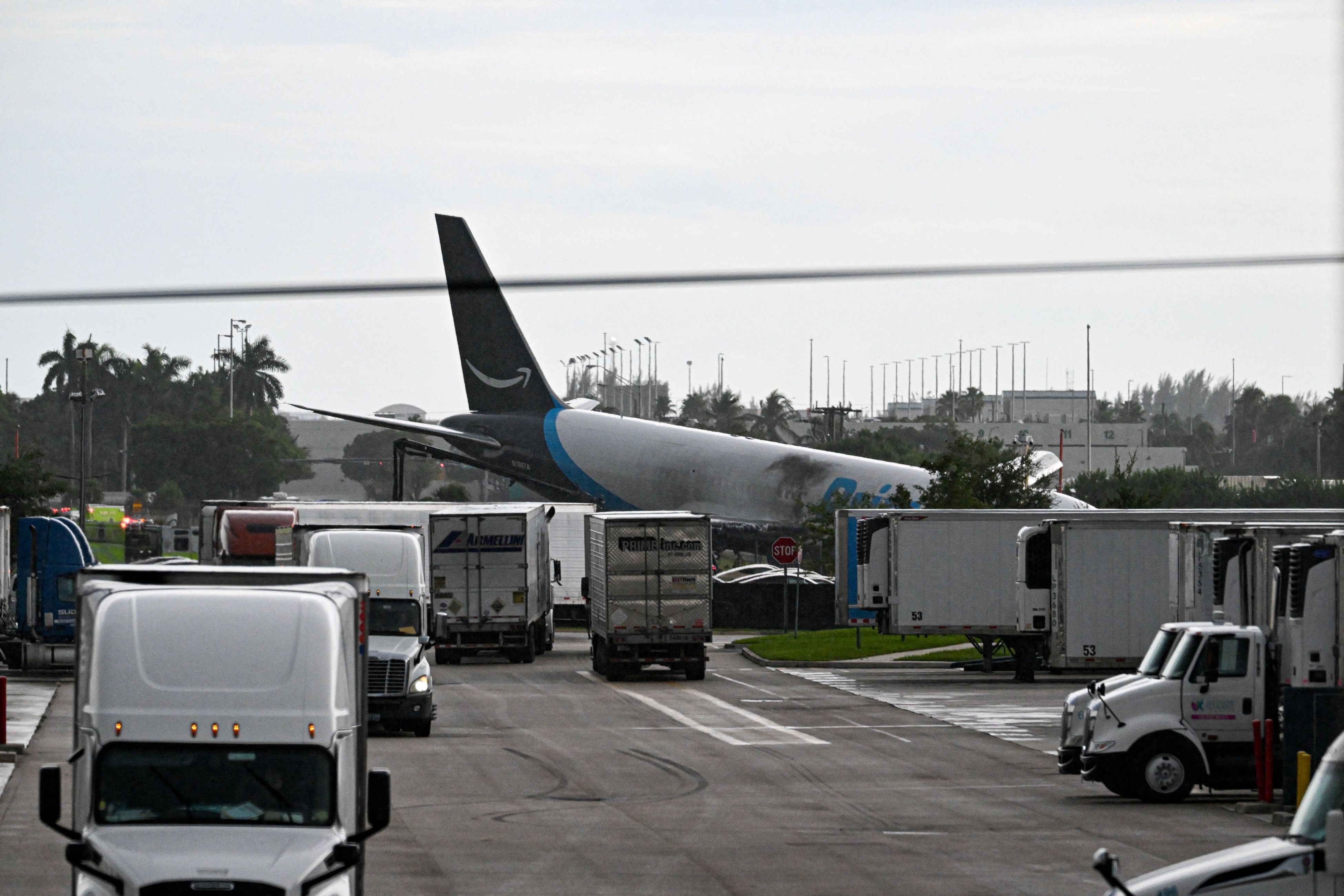 The tail section of a cargo plane is seen at Miami International Airport after it overran the runway at Miami International Airport in Miami, Florida, on September 6, 2026. An Amazon cargo plane overshot a runway as it landed in Miami, crashing in...