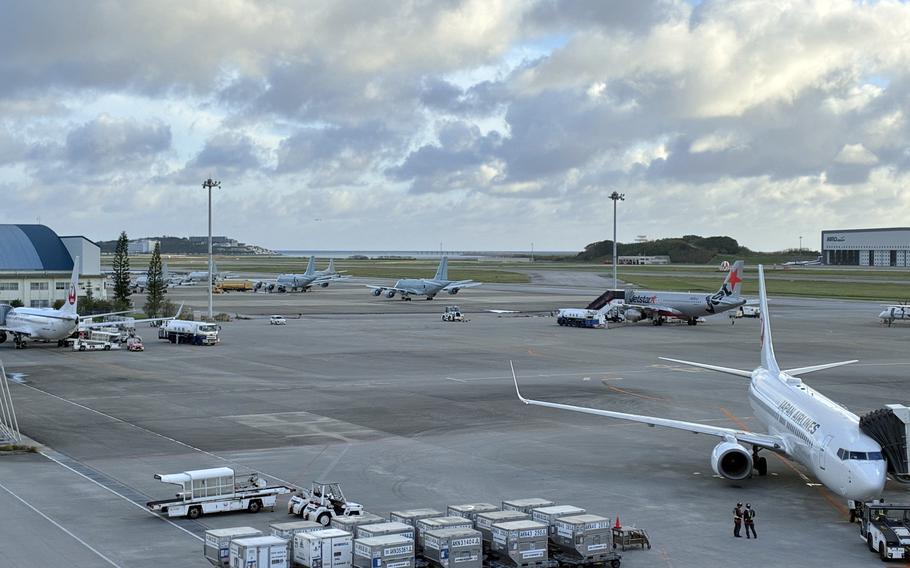 A photo of an airport tarmac with commercial planes parked.