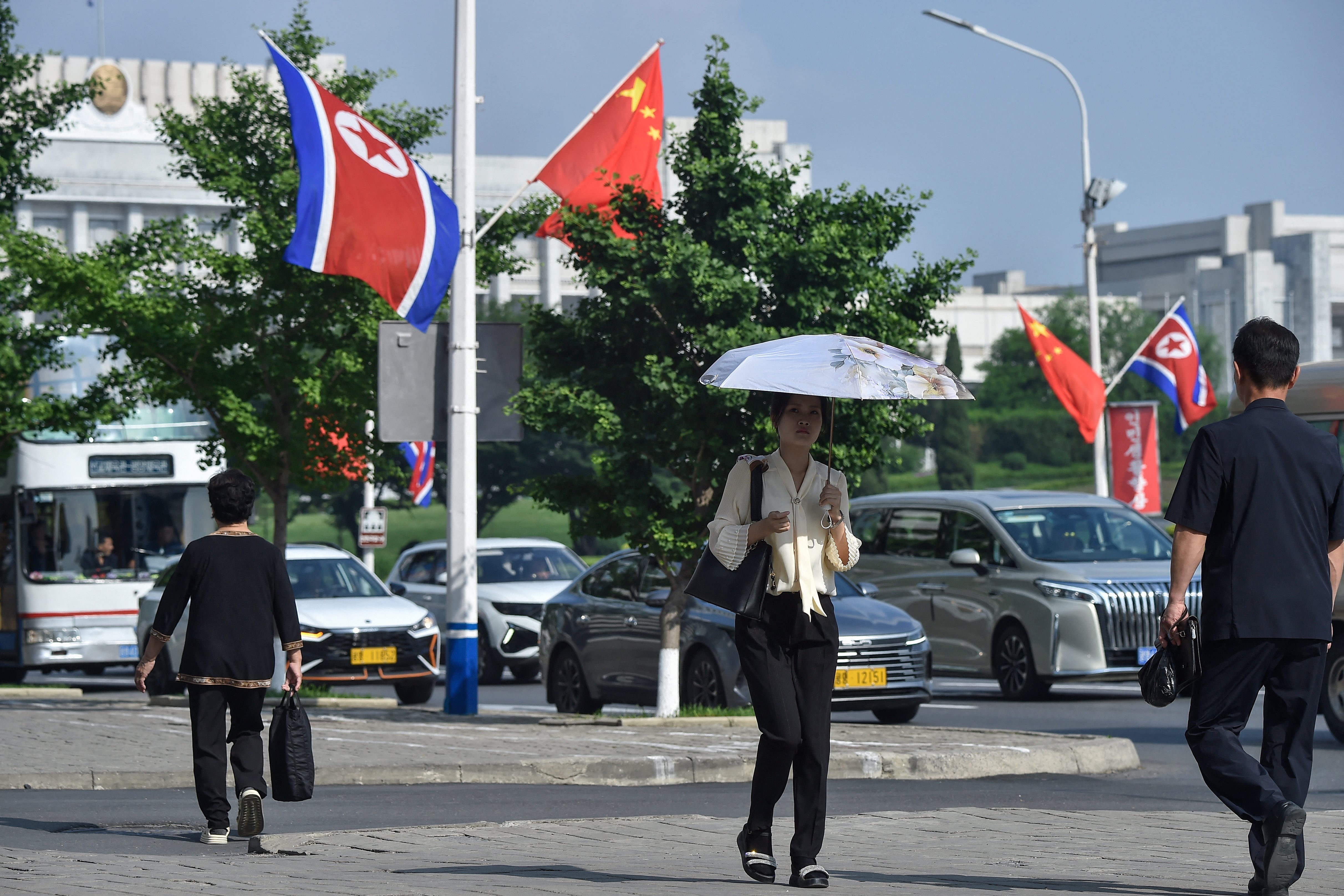 National flags of North Korea and China fly on a street in Pyongyang