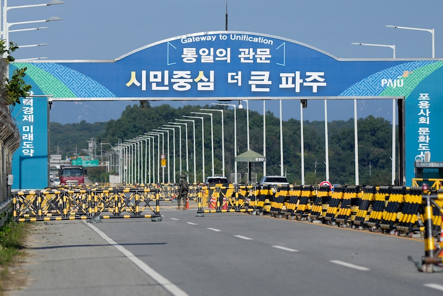 Barricades at a bridge Korean writing on it.