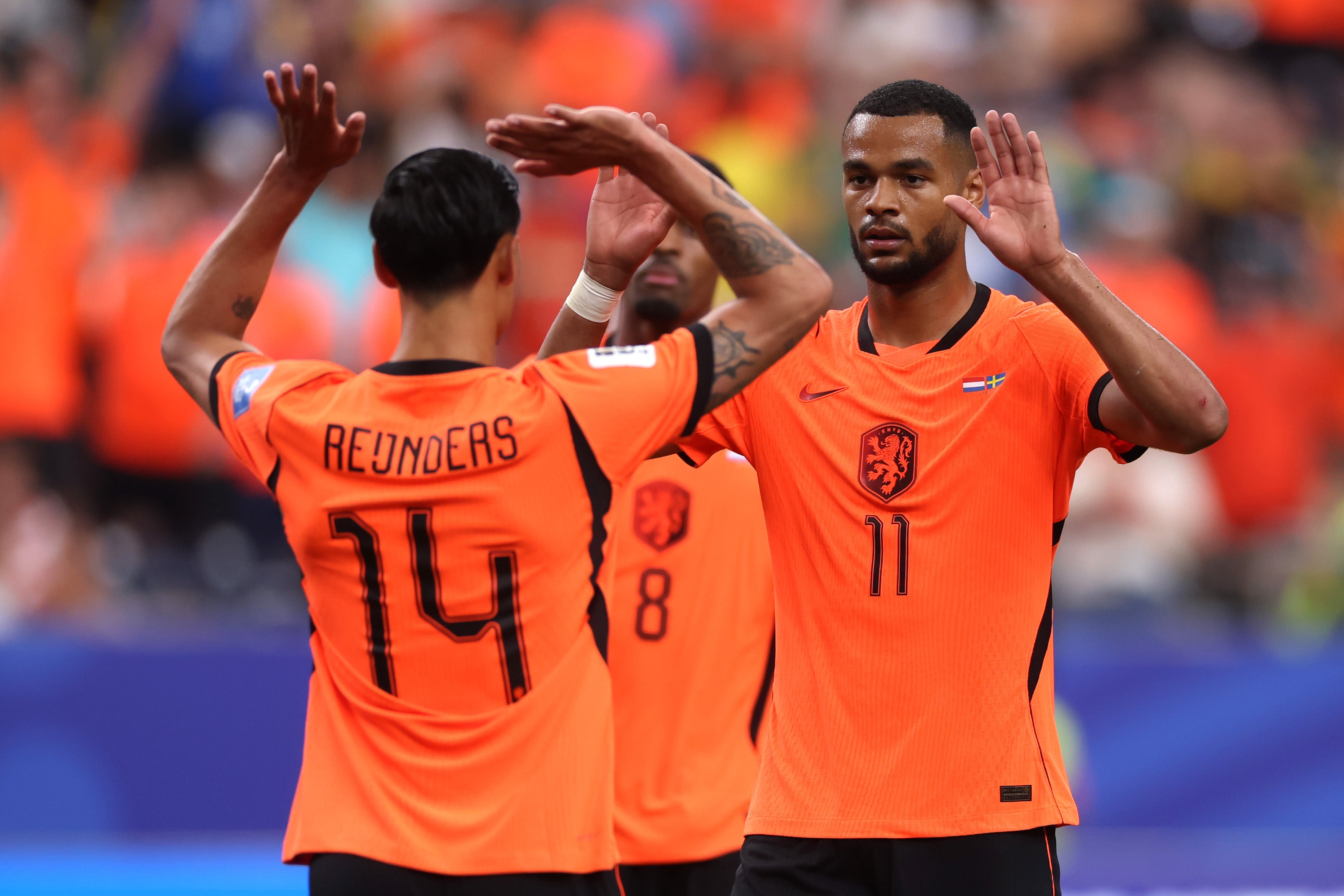 Cody Gakpo celebrates with Netherlands teammate Tijjani Reijnders