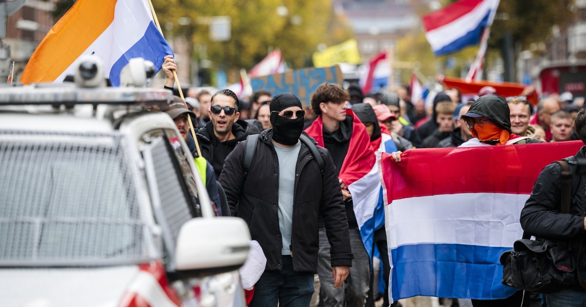 Bij het anti-immigratieprotest lopen demonstranten zowel met de Nederlandse vlag als de Prinsenvlag