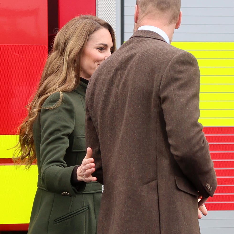 prince william, prince of wales and catherine, princess of wales visit the northern ireland fire rescue service and the princess places an arm over the princes back