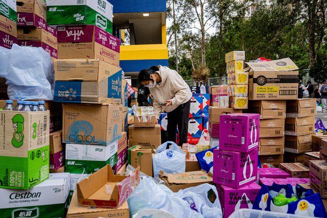 Een vrijwilliger sorteert hulpgoederen in de wijk Tai Po in Hongkong.
