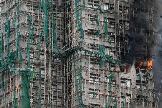 Apartments still burn as a major fire swept through several apartment blocks at the Wang Fuk Court residential estate in Hong Kong's Tai Po district on November 27, 2025. Firefighters were still dousing a devastating fire on November 27 which ripped through a Hong Kong high-rise complex, killing at least 44 people and leaving hundreds missing according to authorities.
