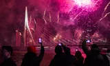 Vuurwerkshow vanaf een ponton op de Nieuwe Maas tijdens het Nationale Vuurwerk bij de Erasmusbrug in Rotterdam. 