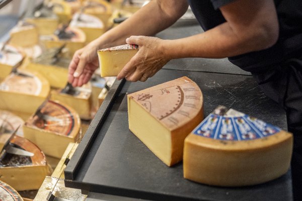 Swiss cheese at the cheese factory is displayed in Sumiswald in the region of Emmental, Switzerland, on Friday, Aug.8, 2025. (Til Buergy/Keystone via AP)
