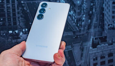 Samsung Galaxy S25 held in hand at an angle to reflect the Samsung logo