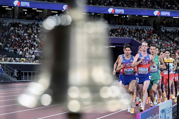 US' athlete Grant Fisher and US' athlete Cole Hocker compete in the men's 5000m final during the World Athletics Championships in Tokyo on September 21, 2025. (Photo by Kirill KUDRYAVTSEV / AFP)