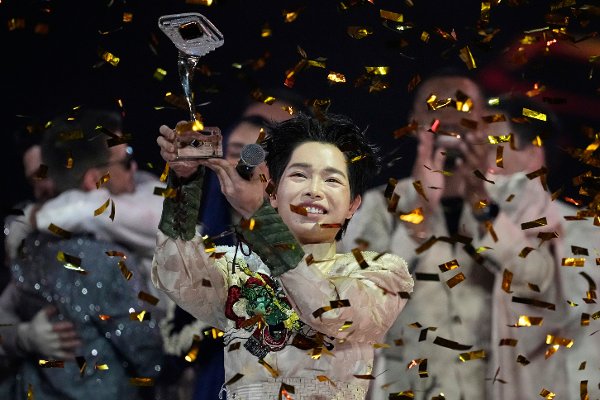 Vietnam's Duc Phuc celebrates with his trophy after winning the International Music Competition 