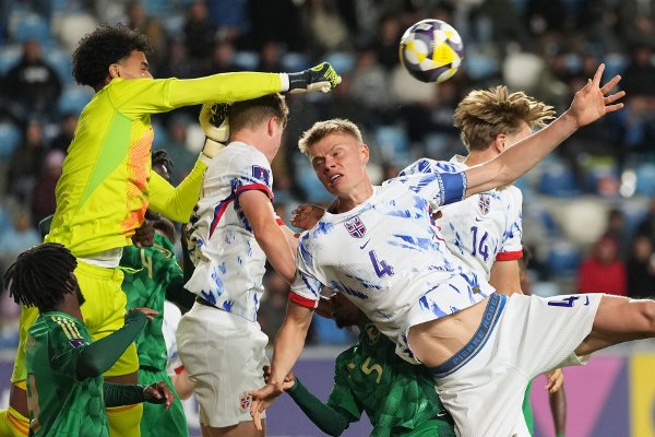 Saudi Arabia's goalkeeper Hamed Yousef clears the ball as Norway's Rasmus Holten (4) attempts a header during a FIFA U-20 World Cup Group E soccer match at El Teniente Stadium in Rancagua, Chile, Sunday, Oct. 5, 2025. (AP Photo/Andre Penner)